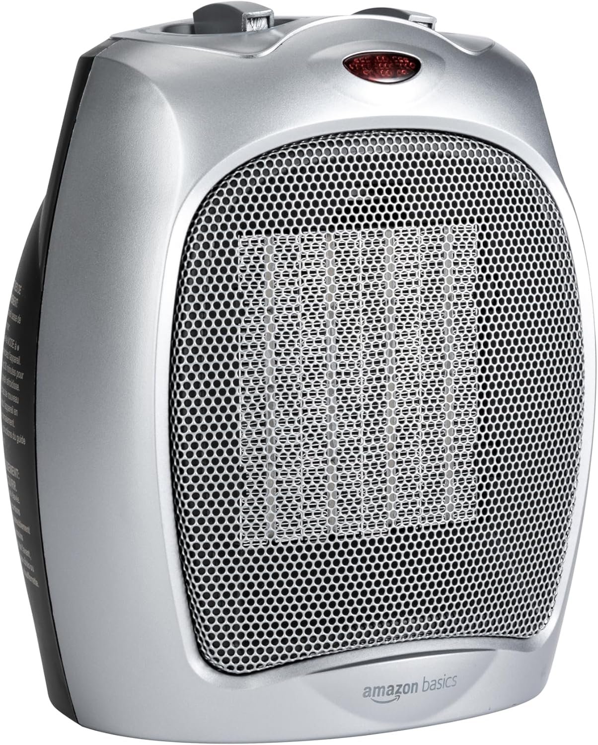 Silver ceramic heater with a large front metal grille, visible ceramic heating element behind the mesh, and a small red indicator light near the top; “amazon basics” logo on the lower front.