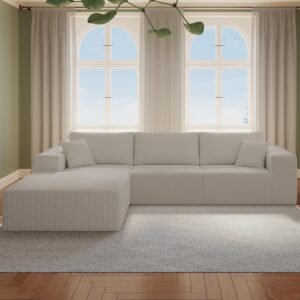 Light gray cloud sectional with left chaise in a bright living room with arched windows and white curtains.